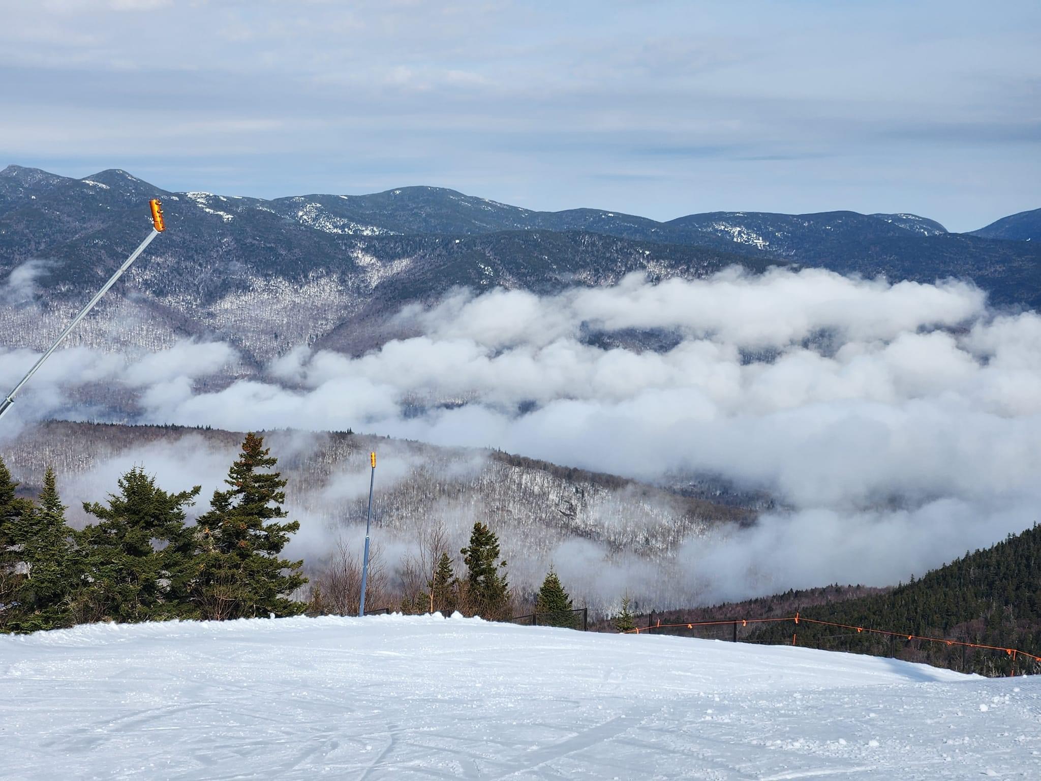 A ski slope rising above the clouds at a First Chair Company resort community